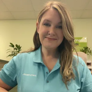 erin is smiling wearing a blue merry maids polo shirt